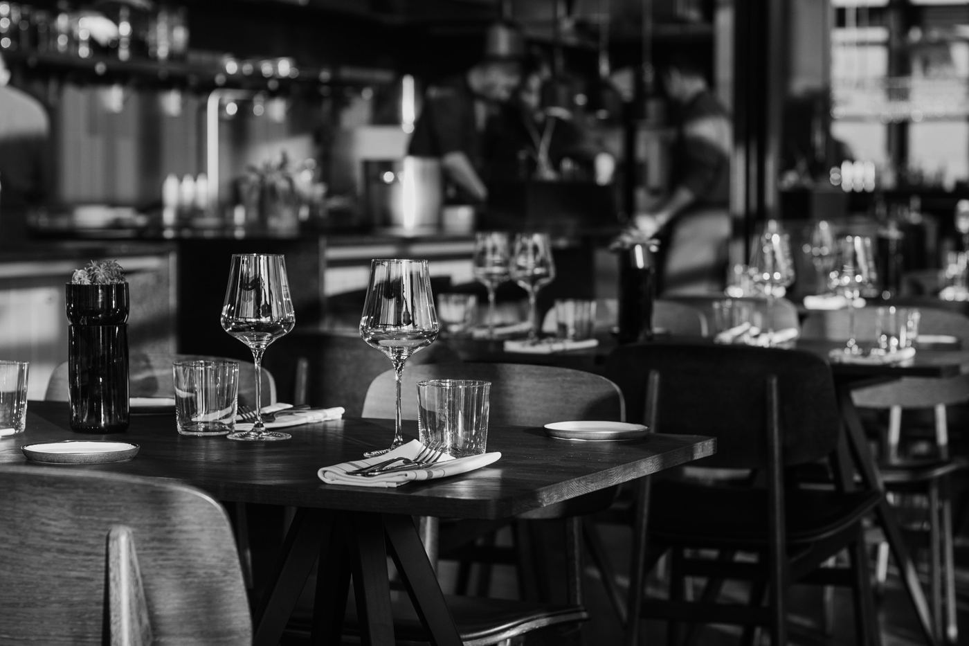 Elegantly set restaurant tables with glassware